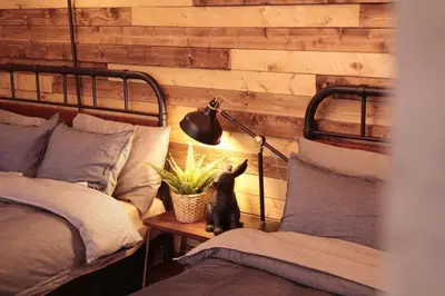 a bedroom with two beds and a lamp and a plant at ACT Residence No.1 201 in Tokyo