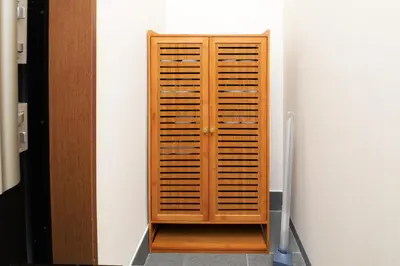 a wooden cabinet in the corner of a room at Shinjuku NY House 2 in Tokyo