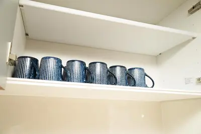 a row of blue bowls on a shelf at Shinjuku NY House 2 in Tokyo