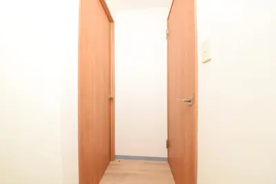 an open door to a hallway with a wooden floor at Shinjuku NY House 2 in Tokyo