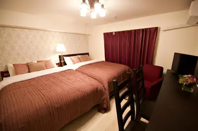 a bedroom with a large bed and a red curtain at Prime Stage Otsuka/Ikebukuro P204 in Tokyo