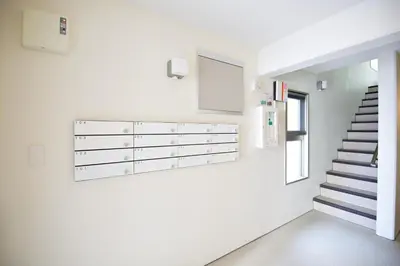 a hallway with white walls and a staircase at Prime Stage Otsuka/Ikebukuro P204 in Tokyo