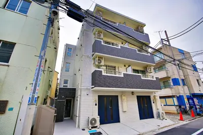 a building with blue doors on the side of it at Prime Stage Otsuka/Ikebukuro P204 in Tokyo