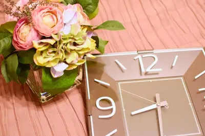 a vase of flowers sitting next to a clock at Prime Stage Otsuka/Ikebukuro P204 in Tokyo