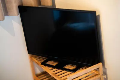a flat screen tv sitting on a stand at Hotel Atelier Tokyo in Tokyo