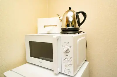 a tea kettle sitting on top of a microwave at Hotel Atelier Tokyo in Tokyo