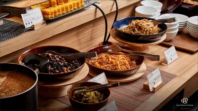 a buffet with bowls of food on a table at Daiwa Roynet Hotel Shimbashi in Tokyo