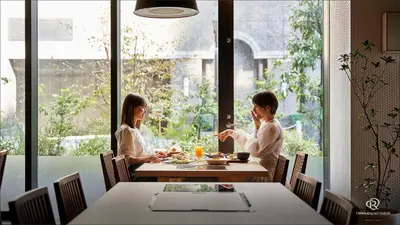 two women sitting at a table eating food at Daiwa Roynet Hotel Shimbashi in Tokyo