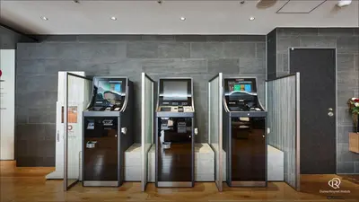 a row of four atm machines against a wall at Daiwa Roynet Hotel Shimbashi in Tokyo