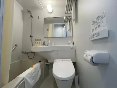 a small bathroom with a toilet and a sink at Okachimachi Urban Hotel in Tokyo