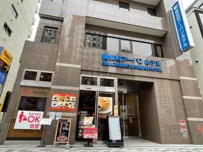 a building with a sign for a dunkin donuts at Okachimachi Urban Hotel in Tokyo