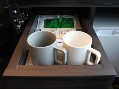 two coffee cups sitting in a wooden drawer at THE BLOSSOM HIBIYA in Tokyo