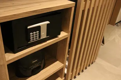 a microwave oven sitting inside of a wooden cabinet at THE BLOSSOM HIBIYA in Tokyo