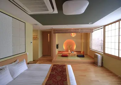 a bedroom with a bed and a couch and a table at Arakawa-ku - Hotel / Vacation STAY 21933 in Tokyo