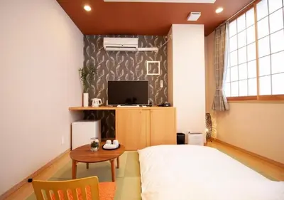 a bedroom with a bed and a table and a tv at Arakawa-ku - Hotel / Vacation STAY 21943 in Tokyo
