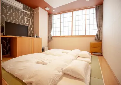 a large white bed in a room with a window at Arakawa-ku - Hotel / Vacation STAY 21943 in Tokyo