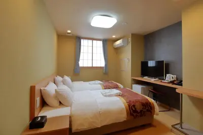 a bedroom with a bed and a desk and a television at Arakawa-ku - Hotel / Vacation STAY 22248 in Tokyo