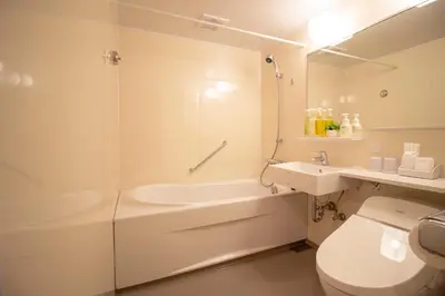 a white bathroom with a tub and a toilet and a sink at Arakawa-ku - Hotel / Vacation STAY 22248 in Tokyo