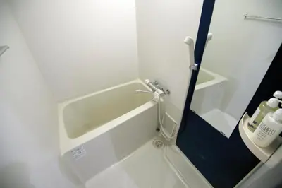a small bathroom with a tub and a sink at Roppongi ClassyHouse902 in Tokyo