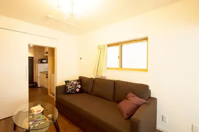 a living room with a couch and a glass table at Roppongi ClassyHouse902 in Tokyo