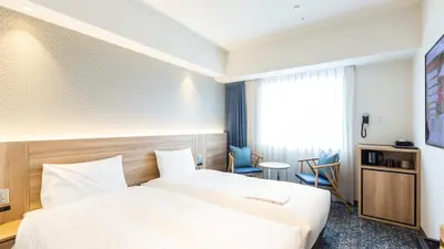 a hotel room with a white bed and a window at Via Inn Prime Nihonbashi Ningyocho in Tokyo