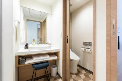 a bathroom with a sink and a toilet at Via Inn Prime Nihonbashi Ningyocho in Tokyo