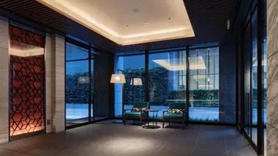 a lobby with a table and chairs and windows at Via Inn Prime Nihonbashi Ningyocho in Tokyo