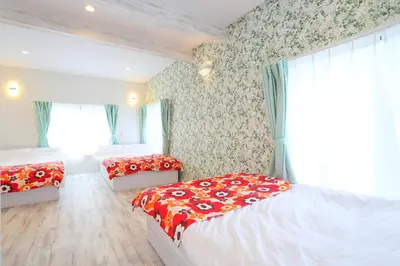 a bedroom with two twin beds and a window at Villa Ikebukuro in Tokyo