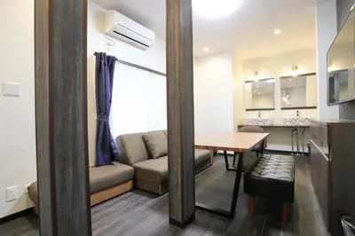 a living room with a couch and a table at Villa Ikebukuro in Tokyo