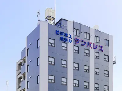 a building with writing on the side of it at Business Hotel Sunpalace in Tokyo