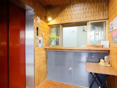 a kitchen with a counter and a window at Business Hotel Sunpalace in Tokyo