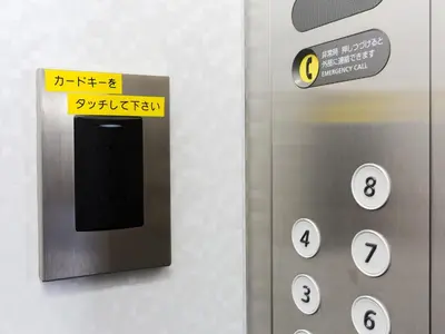 an elevator door with a sign on it at Business Hotel Sunpalace in Tokyo
