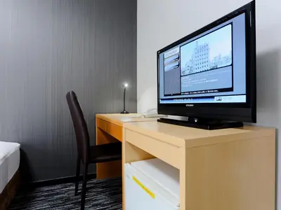 a computer monitor sitting on top of a desk at Business Hotel Sunpalace in Tokyo