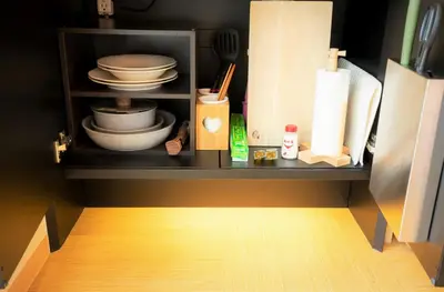 a cabinet with plates and bowls and other kitchen utensils at SOLA HOTEL in Tokyo