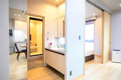 two views of a kitchen and a bathroom in a room at SOLA HOTEL in Tokyo