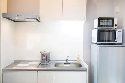 a kitchen with a sink and a microwave at SOLA HOTEL in Tokyo