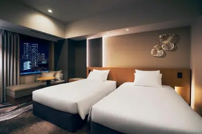 a hotel room with two beds and a window at Hotel JAL City Tokyo Toyosu in Tokyo