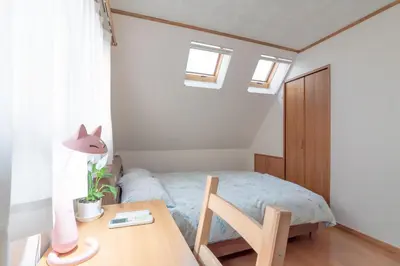 a small bedroom with a bed and a table at Hong house in Tokyo