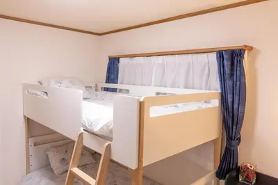 a bedroom with a bunk bed and a window at Hong house in Tokyo