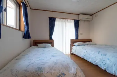 a bedroom with two beds and a window at Hong house in Tokyo