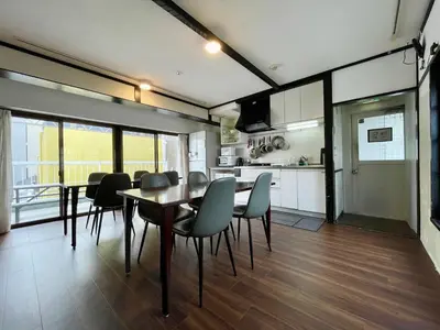 a kitchen and dining room with a table and chairs at Nomad Hostel East in Tokyo