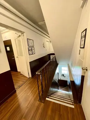a hallway with a staircase in a house at Nomad Hostel East in Tokyo
