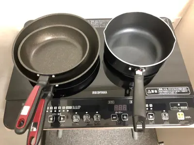 a pair of frying pans sitting on top of a record player at Nomad Hostel East in Tokyo