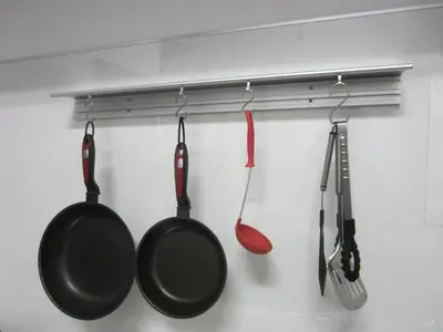 three kitchen utensils hanging on a wall at Nomad Hostel East in Tokyo
