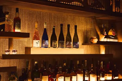 a display of bottles of alcohol on a wall at Kagurazaka Retro BAR & HOTEL in Tokyo