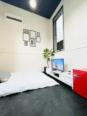 a bedroom with a bed and a tv and a window at Alo BnB 4 - Near KABUKICHO, SHINJUKU, SHINOKUBO, SHIBUYA - Self check-in in Tokyo