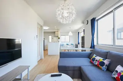 a living room with a blue couch and a table at koiwa house 3LDK free wifi free parking in Tokyo