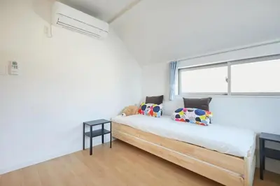 a white bedroom with a bed and a window at koiwa house 3LDK free wifi free parking in Tokyo