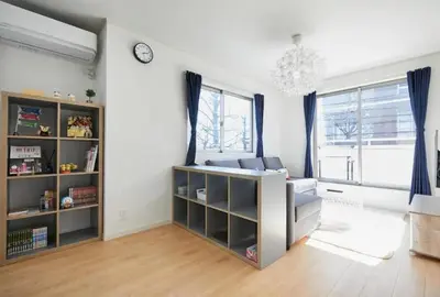 a living room with a couch and a clock on the wall at koiwa house 3LDK free wifi free parking in Tokyo