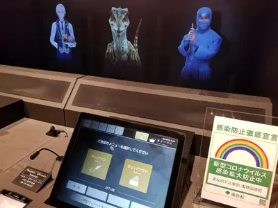 a tablet computer sitting on a table next to a display at Henn na Hotel Premier Tokyo Asakusa Tawaramachi in Tokyo